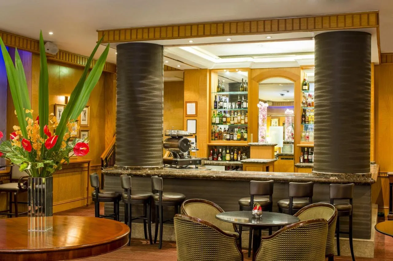 a bar in a restaurant with tables and chairs at Millennium Hotel and Conference Centre Gloucester London in London