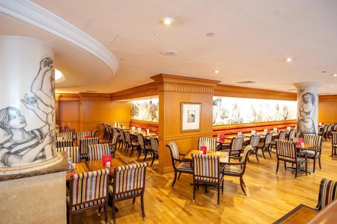 a restaurant with chairs and tables in a room at Millennium Hotel and Conference Centre Gloucester London in London