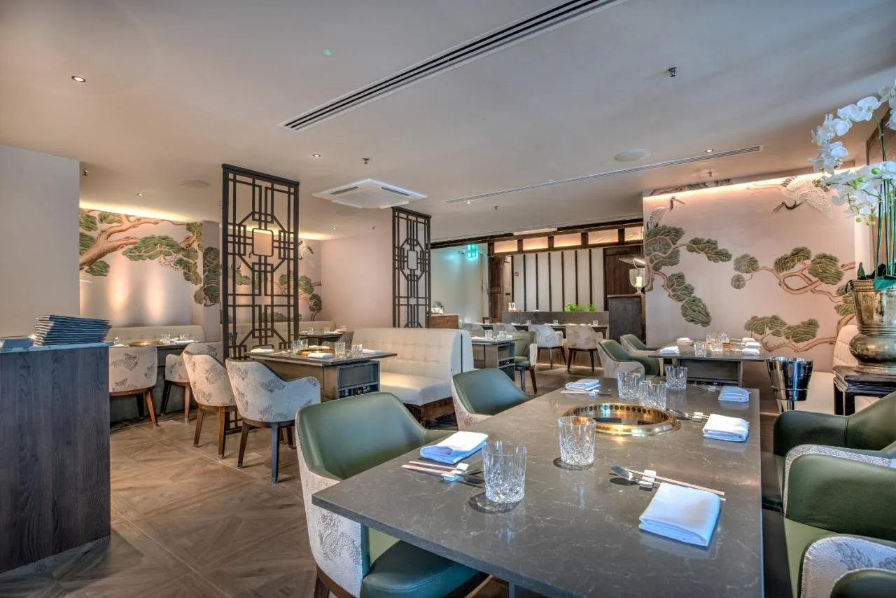 a restaurant with tables and chairs in a room at Millennium Hotel and Conference Centre Gloucester London in London