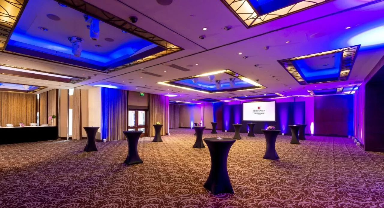 a large room with purple lighting and a stage at Millennium Hotel and Conference Centre Gloucester London in London